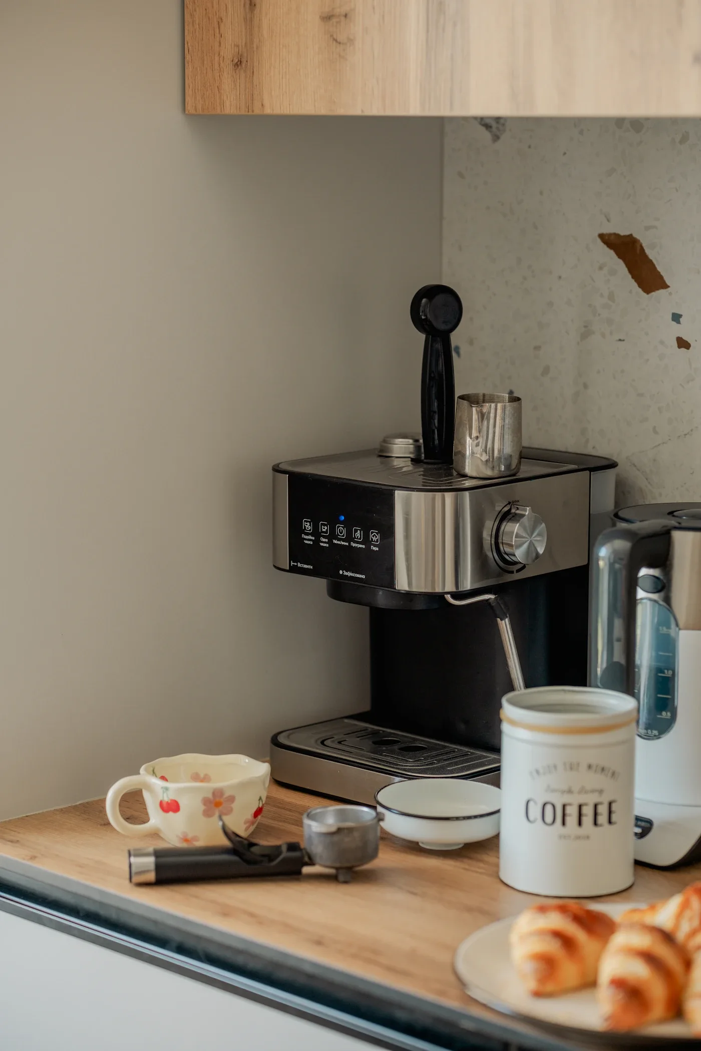 Espresso machine with a grinder and cup on a kitchen counter