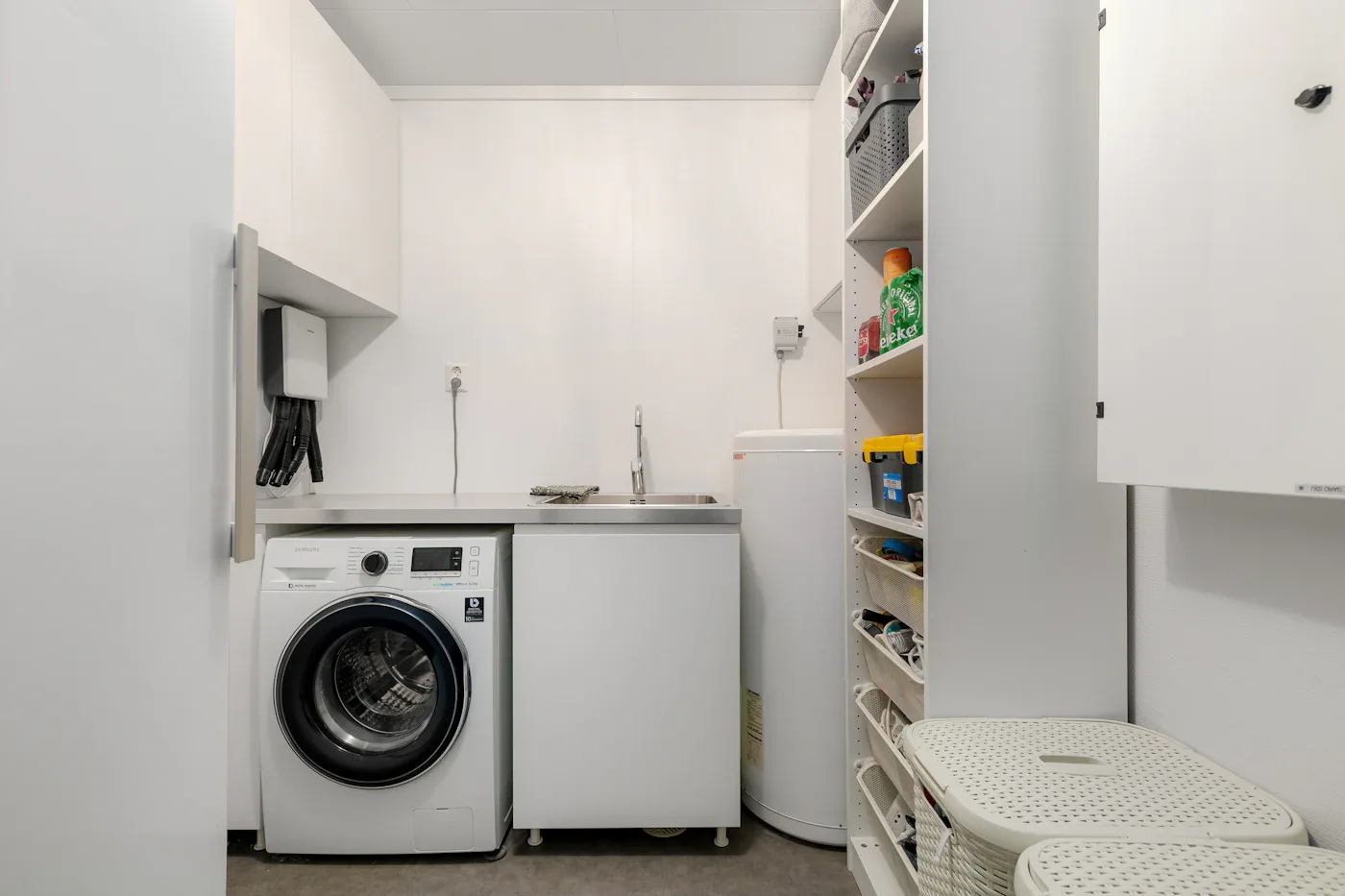 Compact laundry room with a washing machine and open shelving