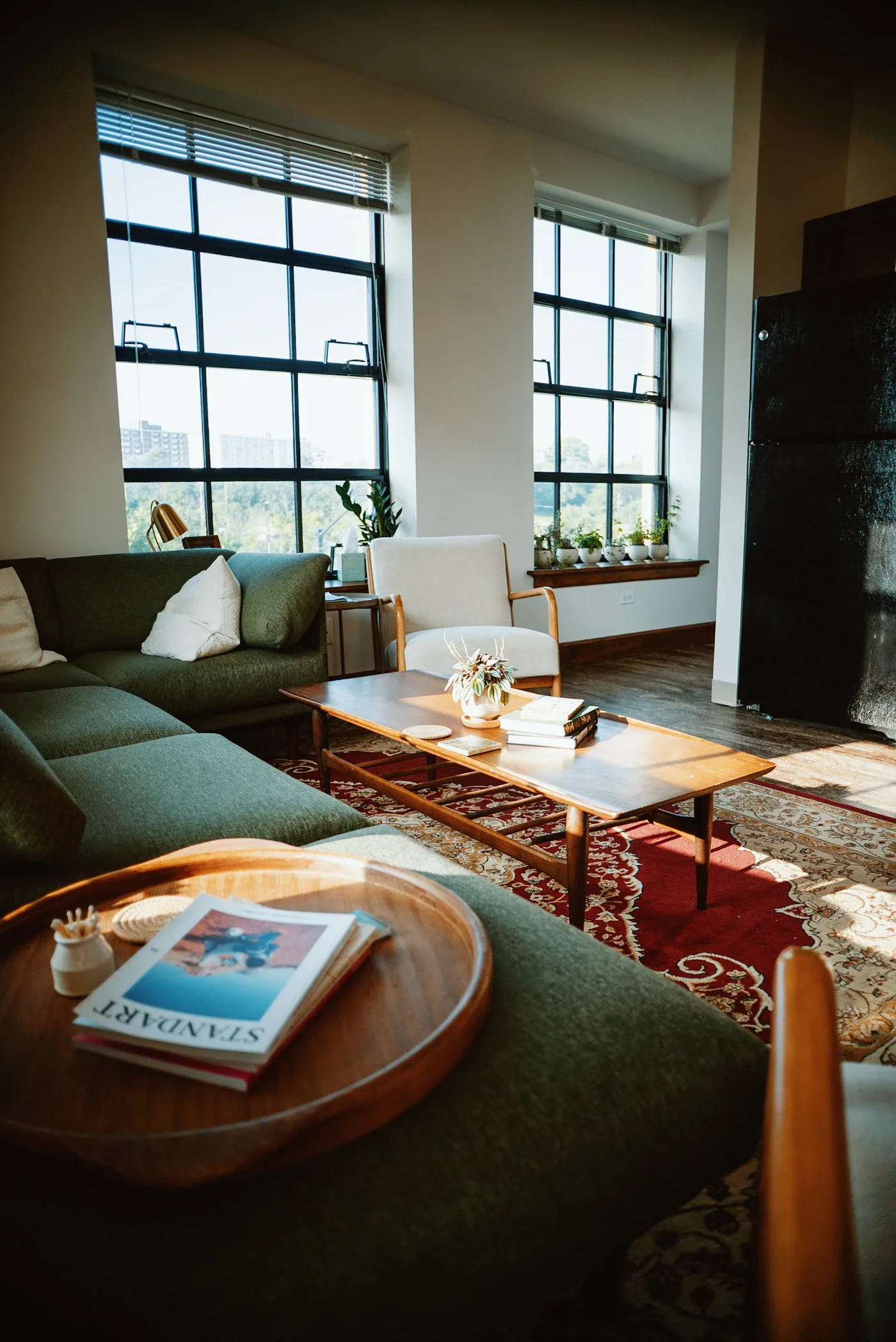 Green sofa and wooden coffee table on a patterned living room rug