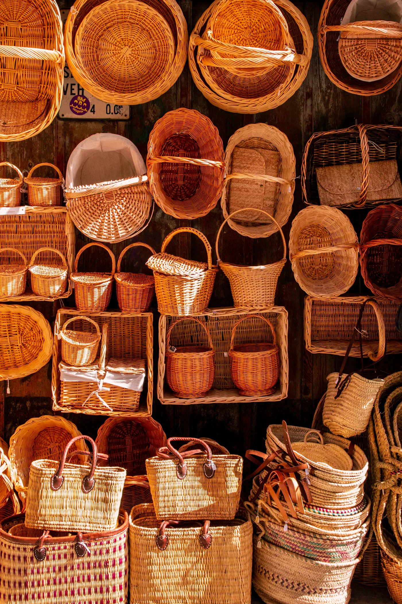 Woven baskets of different sizes displayed on a wall